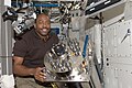 Leland Melvin holds the busted Urine Processor Assembly/Distillation Assembly