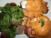 Eggs Benedict prepared with tasso ham, tomato and cajun-style hollandaise sauce