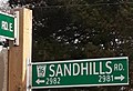 A township road marker imposed on a street name sign blade in Wilmot Township, Waterloo Region, Ontario. The marker is for Wilmot Township Road 16.