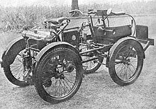 A sepia monotone image of motorized four wheeled vehicle built in 1898 by Royal Enfield.