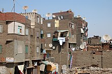 Tenements with satellite dishes and debris