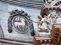 Angel pointing at Agnus Dei above the altar