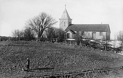 Härjevads gamla träkyrka med tillbyggt torn i trä på sin ursprungliga plats cirka 1900.