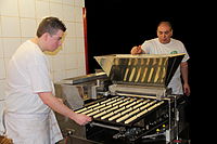 Bakers in Belgium using a machine to make éclairs