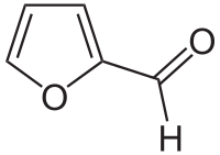 Skeleton formula of a ring of four carbons and one oxygen, with a carbon-oxygen attached to a carbon next to an oxygen