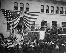 Theodore Roosevelt speaking on platform in front of Pearsons Hall to dense crowd