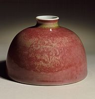 The related copper oxide peach-bloom glaze on a Kangxi water pot, also with incised decoration.