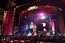 A view of a stage decorated with red curtains and a flying balcony