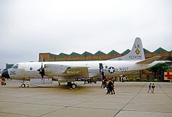 Large plane on the tarmac, with wheels chocked