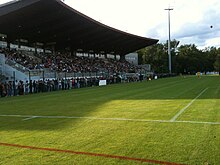 Photographie de côté de la tribune d'un stade de football.