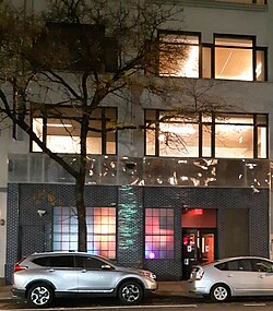 Photograph of an entrance to a building on a city street at night