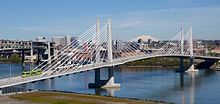 Top: A Type 2 Blue Line train crossing the Steel Bridge Bottom: A MAX train and a Portland Streetcar tram traversing Tilikum Crossing