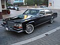 Wire hubcaps mimicking real wire wheels on a 1989 Cadillac Brougham