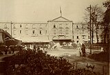 A black-and-white postcard of a hotel with a restaurant