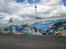 The boardwalk outside the New York Aquarium, with a mural on the aquarium wall