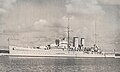 HMS Exeter at the Royal Naval Dockyard with Gibb's Hill Lighthouse beyond, ca 1936