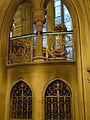 Gothic style ironwork, on the lower flight of the Main Staircase, Manchester Town Hall, with typical Waterhouse glass in the background