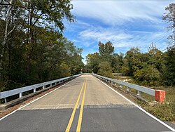 Bridge over Chunky River with Kansas City Southern crossing in the background in Point, Mississippi