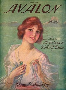 Vintage poster of a woman smiling; she has a round face, short, wavy, ginger hair and a light 1920s dress