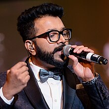 Rahul Nambiar singing at a concert in US