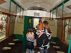 Old-fashioned British railcar has hanging straps without looped handles