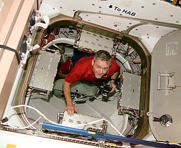 Garneau floats in the hatchway that leads to Endeavour