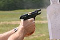 Beretta M9 semi-automatic pistol exhibiting muzzle rise just after firing a 9×19mm Parabellum cartridge.