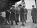 Royal Air Force officers in uniform greatcoat, inspecting a French aeroplane.