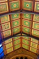 The painted ceiling, North Hall, Natural History Museum c.1881, designed by Waterhouse, painted by Charles James Lea of the firm of Best & Lea, depicting native British plants, subdued colour palette with subtle gilded highlights is used, note the unobtrusive cast-iron roof trusses, very different from his wooden roofs