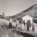 Students of the Little Outfit Schoolhouse raising the US flag in 1943