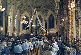 During a religious ceremony, interior of the church of Sainte-Anne[14]