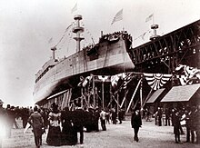 Photograph of Kearsarge. Kentucky is on her right, and crowds surround both.