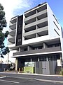 One of the new multi-storey apartment buildings in St Marys, a result of development in anticipation of the new metro line to the Badgerys Creek Aerotropolis. There is also a large print photo depicting a Bennett wagon (lower middle) - a remembrance of the suburb's past in the wake of progress and modernization