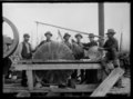 Sawmill workers posing with saw blades, Rainy River District, 1900–1909