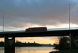 Passage d'un camion sur le viaduc de la Maine au soleil couchant ; en arrière-plan, la ville d'Angers, Aire urbaine d'Angers