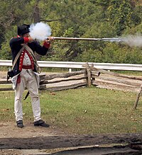 A flintlock musket being fired