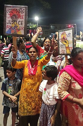 protestor in street holding sign demanding justice