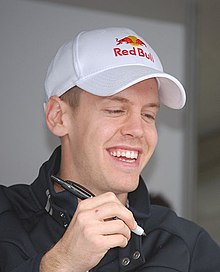 Foto dari Sebastian Vettel yang sedang tersenyum, pembalap Tim Toro Rosso yang nantinya menjadi pembalap Red Bull.