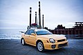 Subaru Impreza S202, a high-performance variant of the standard Subaru Impreza WRX sedan. This photo shows the front of the car, which is yellow; there is a "S202" badge on the front grille.