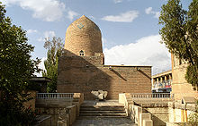 Large brick building with a rounded column