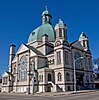 A grand limestone church building with a massive dome