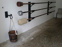 Historical bore cleaning equipment for a cannon.