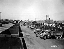 lines of trucks loading and unloading