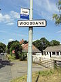 Woodbank sign and bus stop, A540