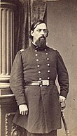 American Civil War officer with long goatee standing with sword