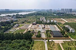 Ruins of Yanshi Shang City with the skyline of Yanshi District in the background