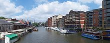 The view north from Redcliffe Bridge, showing one yellow water taxi, warehouses and various buildings along Welsh Back