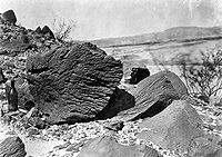 Rock carved by drifting sand below Fortification Rock in Arizona.