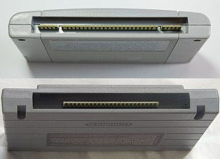 A photo showing the bottom ends of a PAL SNES / Japanese SFC cartridge and a North American SNES cartridge.