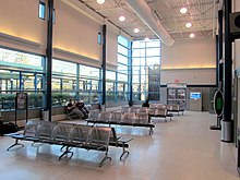 A waiting room in a glass-walled station